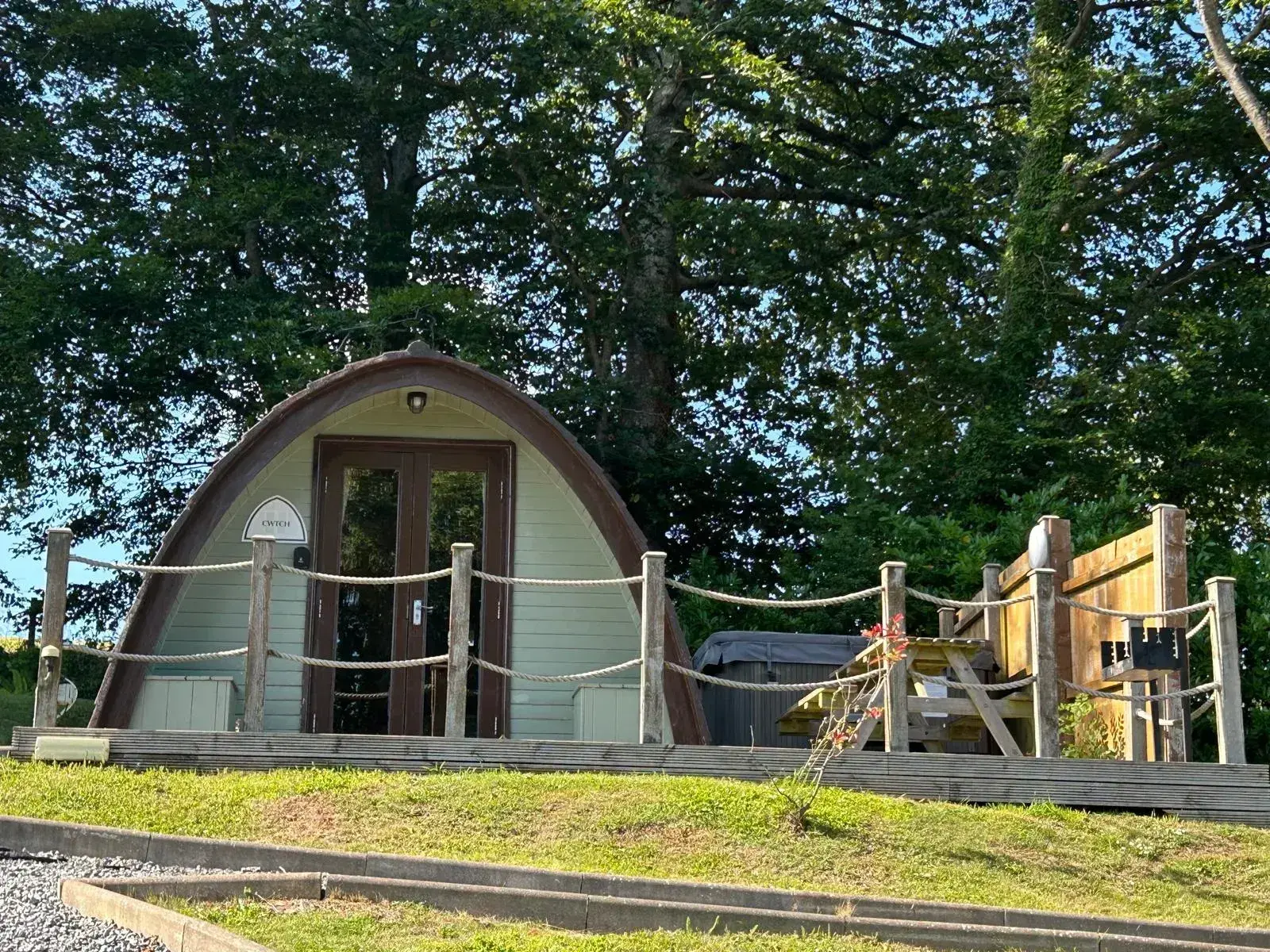 Jacuzzi Pod exterior in the evening light, with the private 6-seater tub visible on the decking