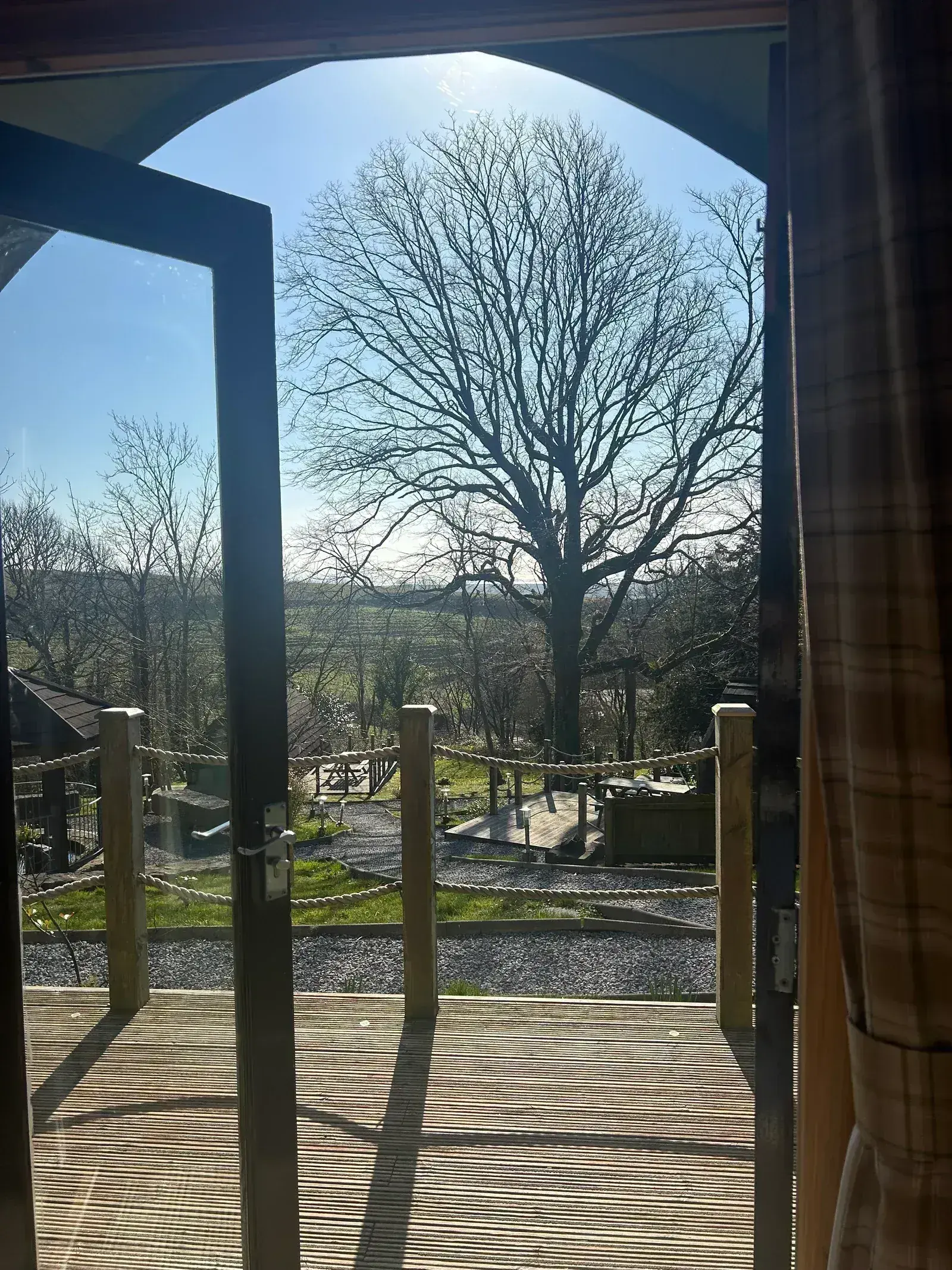 View across the Carmarthenshire countryside from a glamping pod doorway and private decking