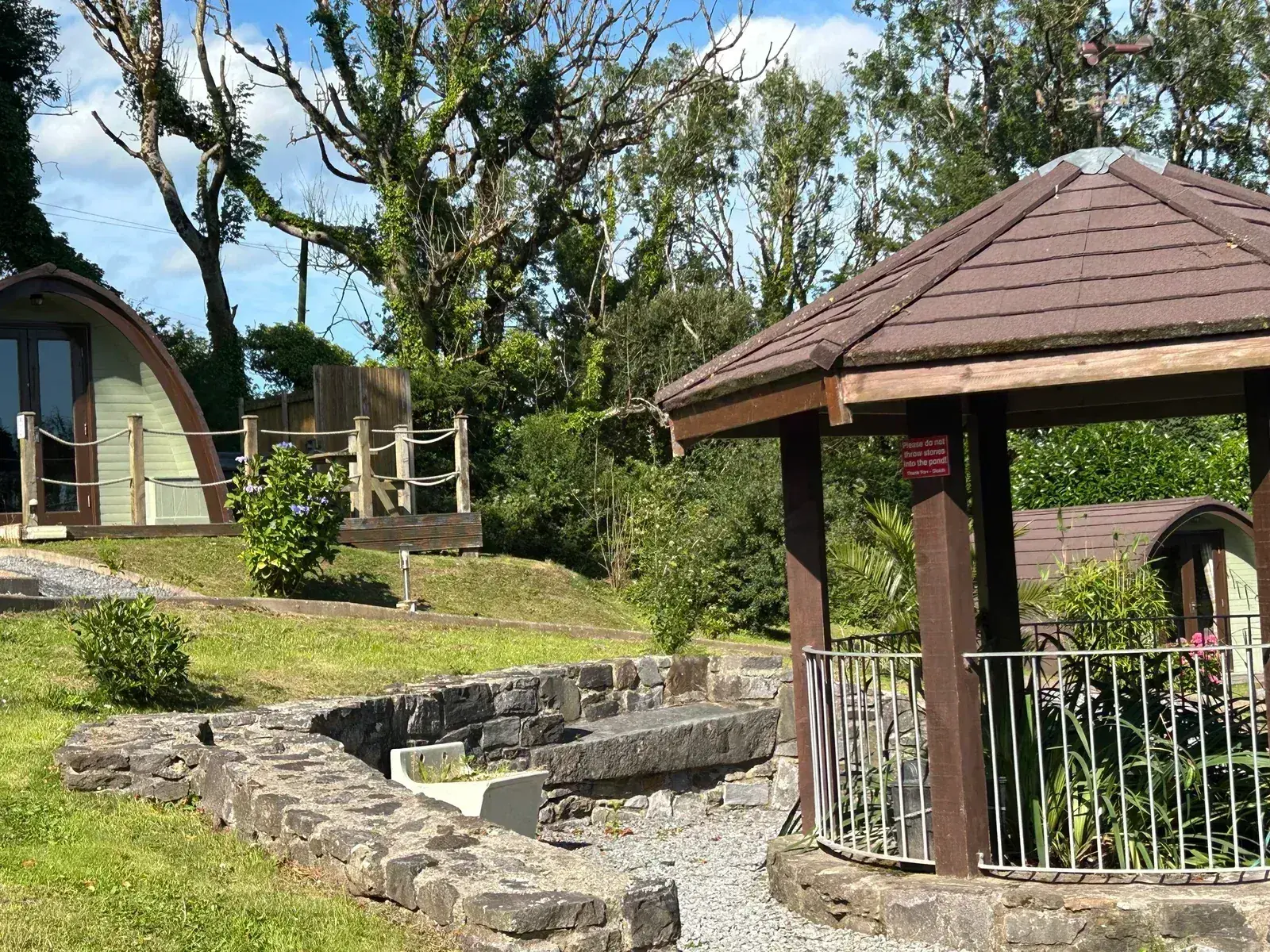 Covered gazebo and stone water feature in the landscaped grounds at Pods @ Broadway