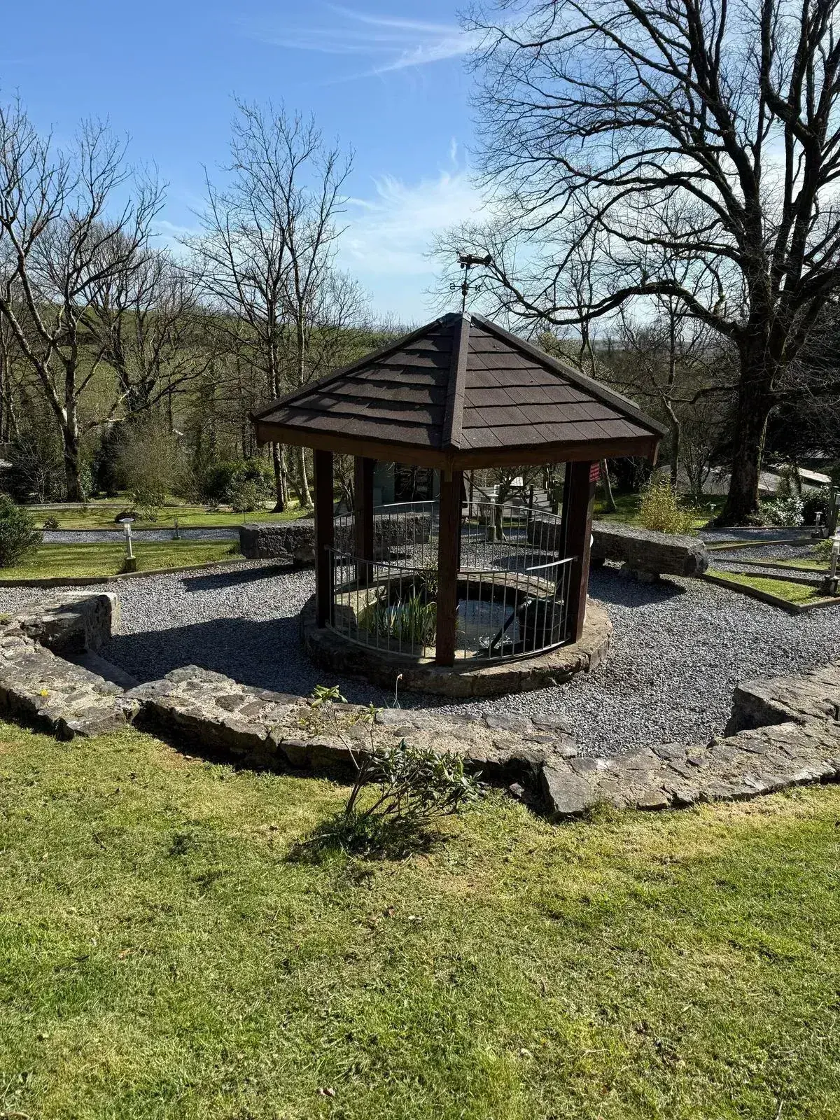 Covered gazebo seating area with stone wall surrounds — perfect for outdoor dining